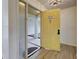 Inviting home entryway with a yellow door, wood-look flooring and access to a sunroom patio at 263 Southampton Dr # 301, Venice, FL 34293