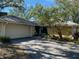 Charming single-story home featuring a two-car garage, mature landscaping, and a well-maintained lawn at 263 Southampton Dr # 301, Venice, FL 34293