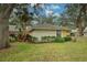 Exterior elevation of a home with lush landscaping and mature trees at 263 Southampton Dr # 301, Venice, FL 34293