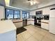 Bright kitchen with white cabinets, stainless steel appliances, and a view of the pool at 263 Southampton Dr # 301, Venice, FL 34293