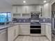 Well-equipped kitchen featuring stainless steel appliances, stone countertops and custom cabinets at 263 Southampton Dr # 301, Venice, FL 34293