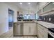 Kitchen area with stone countertops, stainless steel dishwasher, and wood cabinets at 263 Southampton Dr # 301, Venice, FL 34293