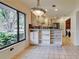 Bright kitchen with stainless steel appliances, custom cabinets, and an eat-in dining area at 263 Southampton Dr # 301, Venice, FL 34293