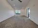 Spacious living room featuring carpet flooring, large windows, and recessed lighting at 263 Southampton Dr # 301, Venice, FL 34293