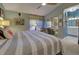 Spacious main bedroom with ceiling fan, ensuite bathroom, and sliding closet doors at 263 Southampton Dr # 301, Venice, FL 34293