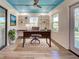 Bright home office featuring custom built-ins, modern lighting, and a beautiful wood desk and chair at 263 Southampton Dr # 301, Venice, FL 34293