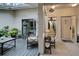 Enclosed patio with comfortable seating, multiple plants and a sliding glass door entering the house at 263 Southampton Dr # 301, Venice, FL 34293