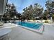 Inviting community pool surrounded by lush landscaping and lounge chairs at 263 Southampton Dr # 301, Venice, FL 34293