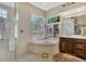 Spa-like bathroom with soaking tub and walk-in shower at 2878 Egret Ct, North Port, FL 34287