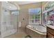 Bathroom features a walk-in shower and a soaking tub at 2878 Egret Ct, North Port, FL 34287