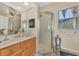 Bathroom features a shower, vanity with sink and mirror at 2878 Egret Ct, North Port, FL 34287