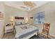 Guest bedroom with a queen-size bed, ceiling fan, and window coverings at 2878 Egret Ct, North Port, FL 34287