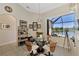 Bright breakfast nook with glass table and chairs, offering water views at 2878 Egret Ct, North Port, FL 34287