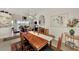 Bright dining room with a wood table, large art piece, and views to living room at 2878 Egret Ct, North Port, FL 34287