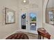 Bright and spacious entryway with double doors and decorative mirror at 2878 Egret Ct, North Port, FL 34287