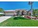 One-story home with tile roof, landscaped yard, and attached garage at 2878 Egret Ct, North Port, FL 34287