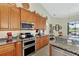 Bright kitchen with granite countertops and stainless steel appliances at 2878 Egret Ct, North Port, FL 34287