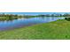 Serene waterfront view with lush green grass at 2878 Egret Ct, North Port, FL 34287