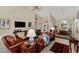 Open concept living room with leather sofas and views into dining and entry areas at 2878 Egret Ct, North Port, FL 34287