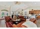 Open and bright living room with comfortable seating and views into kitchen and entry at 2878 Egret Ct, North Port, FL 34287