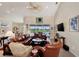 Relaxing living room featuring leather seating, a large TV, and scenic views at 2878 Egret Ct, North Port, FL 34287