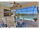 Enjoy relaxing views from the covered patio overlooking the pool and lake at 2878 Egret Ct, North Port, FL 34287