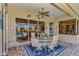 Covered patio with outdoor seating, offering tranquil lake views at 2878 Egret Ct, North Port, FL 34287