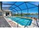 Enjoy this screened pool and spa overlooking a peaceful lake at 2878 Egret Ct, North Port, FL 34287