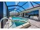 Relaxing screened pool and spa with a spacious patio area at 2878 Egret Ct, North Port, FL 34287