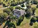An aerial view of the property with a screened patio and trees at 3200 Rowland Dr, Punta Gorda, FL 33980