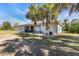 Backyard view of the home with palm trees and some equipment at 3200 Rowland Dr, Punta Gorda, FL 33980