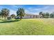 Spacious backyard with grassy area and view of the back of the house at 3200 Rowland Dr, Punta Gorda, FL 33980