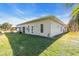 Exterior view of the back of the home and grassy backyard at 3200 Rowland Dr, Punta Gorda, FL 33980