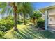 Tropical backyard with lush landscaping and palm trees at 3200 Rowland Dr, Punta Gorda, FL 33980