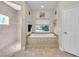 Modern bathroom featuring a tiled shower, a soaking tub, and neutral-toned finishes at 3200 Rowland Dr, Punta Gorda, FL 33980