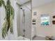 Clean and simple bathroom with tiled shower and palm tree shower curtain at 3200 Rowland Dr, Punta Gorda, FL 33980