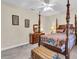 Cozy bedroom with four-poster bed, dresser, and decorative trunk at 3200 Rowland Dr, Punta Gorda, FL 33980