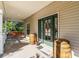 Front porch with double door entry, swing, and decorative barrels at 3200 Rowland Dr, Punta Gorda, FL 33980