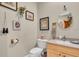 Quaint half bath with unique wall decor and a pedestal sink at 3200 Rowland Dr, Punta Gorda, FL 33980