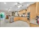 Kitchen with stainless steel appliances, wood cabinetry, and tile flooring at 3200 Rowland Dr, Punta Gorda, FL 33980