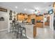 Spacious kitchen with ample wood cabinetry, and an island with bar seating at 3200 Rowland Dr, Punta Gorda, FL 33980
