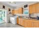 Laundry room with washer, dryer, cabinets, and tile floor at 3200 Rowland Dr, Punta Gorda, FL 33980