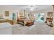 Spacious main bedroom with carpeted floors, four-poster bed, and access to a private patio at 3200 Rowland Dr, Punta Gorda, FL 33980