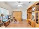 Home office with wood floors, built-in shelving, and a ceiling fan at 3200 Rowland Dr, Punta Gorda, FL 33980