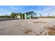 Exterior view of a light green outbuilding with a gravel driveway at 3200 Rowland Dr, Punta Gorda, FL 33980