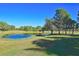 Pond with a gazebo surrounded by trees and grass at 3200 Rowland Dr, Punta Gorda, FL 33980