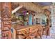 Outdoor tiki bar with a thatched roof, wooden bar stools, and tropical decor at 3200 Rowland Dr, Punta Gorda, FL 33980