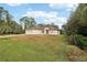 Elevated view of the house exterior, front yard, and surrounding greenery at 3978 Weidman Ave, North Port, FL 34286