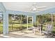 Screened patio with a ceiling fan, seating, and backyard views at 413 Gulf Dr, Venice, FL 34285