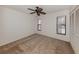 Bright bedroom featuring carpet flooring and a ceiling fan at 4301 Oak Terrace Cir, Port Charlotte, FL 33953